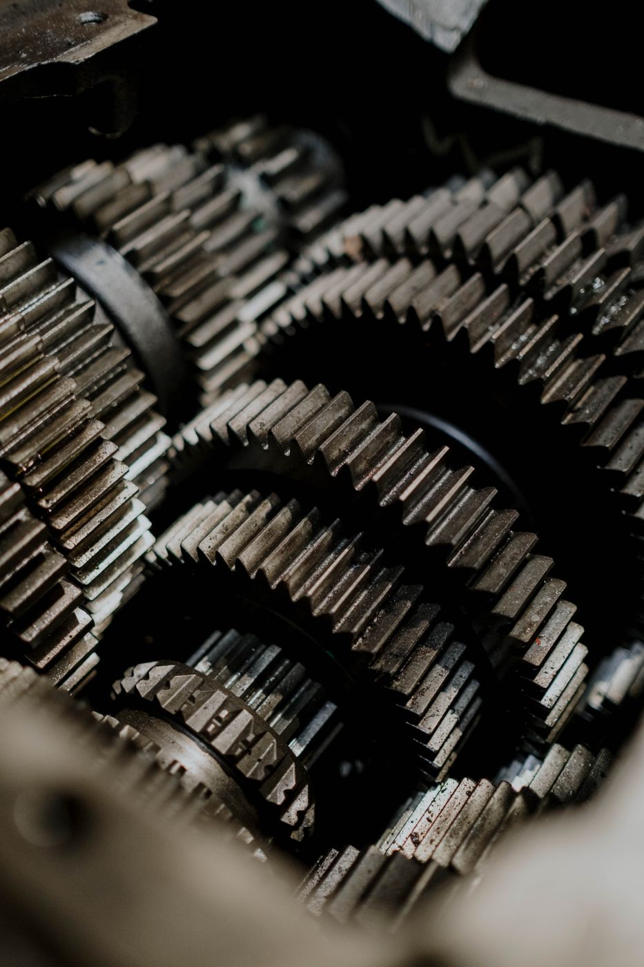 Ranks of identical machined gears representing repeatable cryogenic deburring at production volume